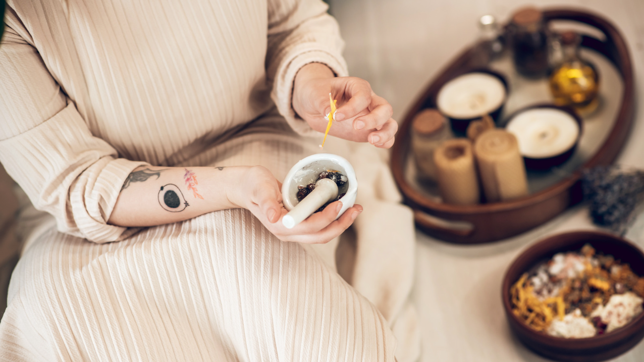 woman crushing herbs for her Ayurvedic lifestyle