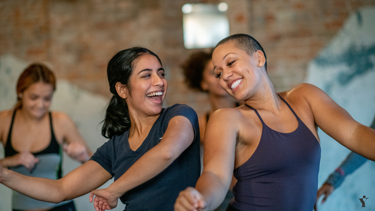 two women enjoying a yoga class together