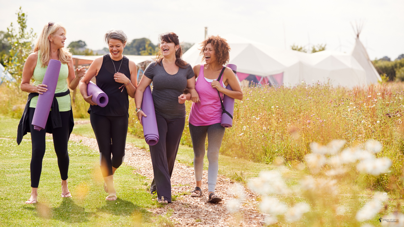 four women with yoga mats, walking away from the retreat centre happy and chatty