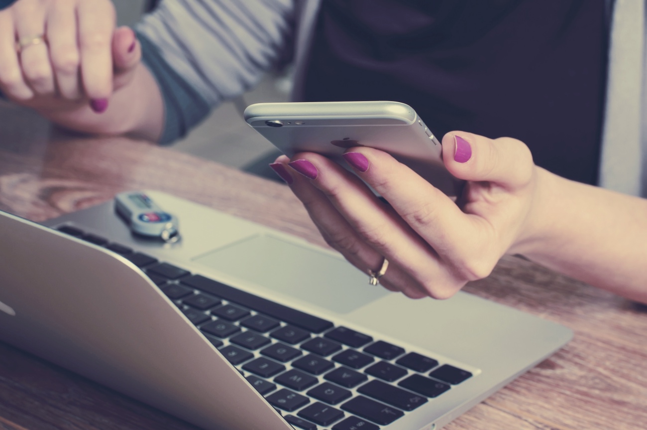 Woman using social media and Facebook on her phone